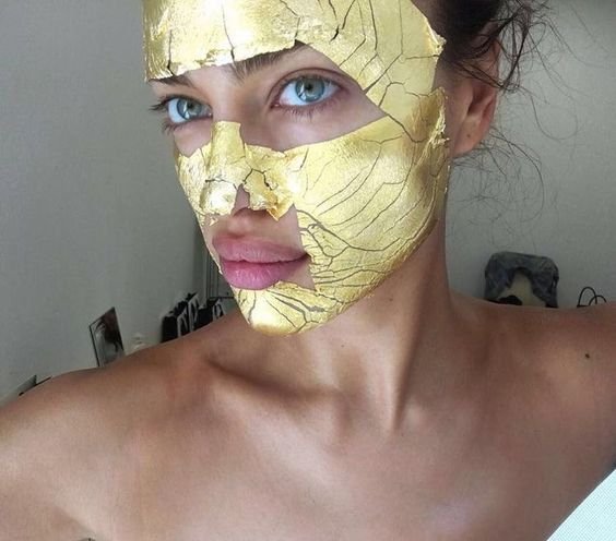 Gold face mask on Irina Shayk