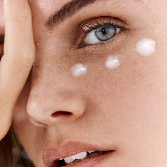 Eye cream on woman face