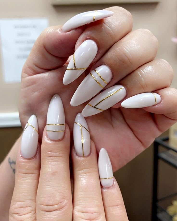 gold lines and white nails