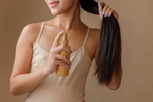 women detangling hair spray